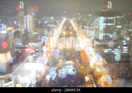Blurred Night Lights and Bokehs of Odori Park in Rainy Day Scenery from Sapporo TV Tower. Stock Photo