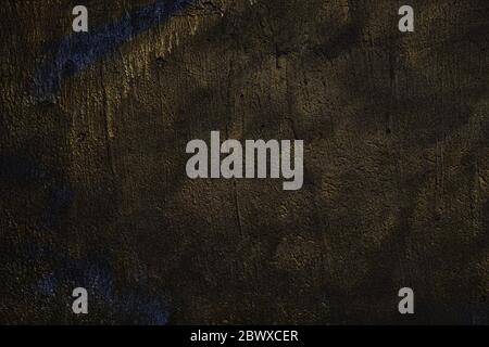 Abstract Beautiful Gold Paint on Grunge Concrete Wall Texture Background in Dark Tone. Stock Photo