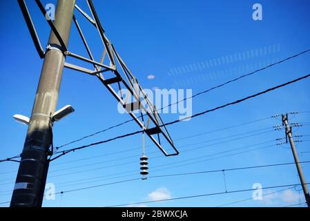 Scenery of Electric Pole from Train Window with Light Bulb Reflection on the Glass. Stock Photo