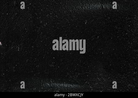 White Paint Splatters on Black Concrete Wall Texture Background. Stock Photo
