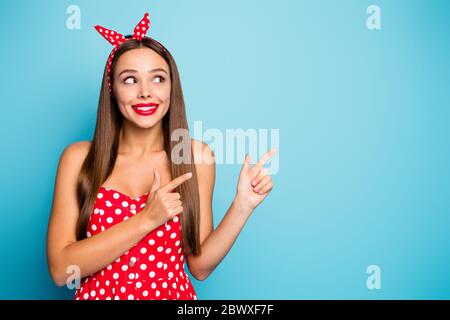 Close-up portrait of nice-looking attractive lovely glamorous curious cheerful cheery straight-haired girl showing new novelty isolated over bright Stock Photo