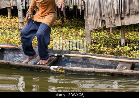 Africa, West Africa, Benin, Lake Nokoue, Ganvié. A young man is walking on a pirogue. Stock Photo