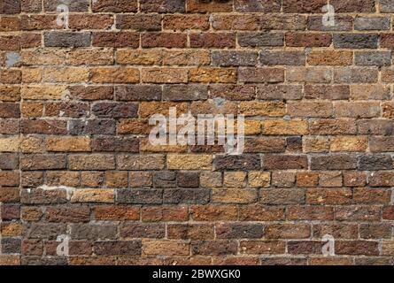 Background of rough texture brick in shades of brown, tan, and gray, creative copy space, horizontal aspect Stock Photo