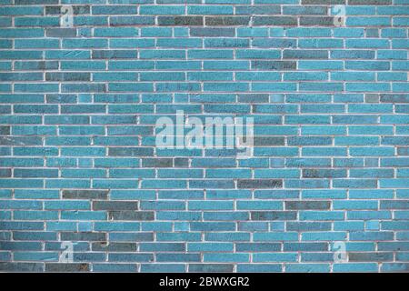 Blue background of long brick featuring a finely grooved surface texture, colorful copy space, horizontal aspect Stock Photo