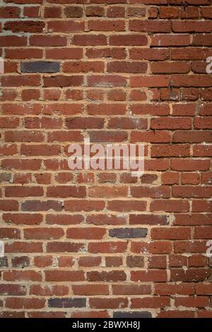 Tall brick wall background, vintage weathered brick partially repointed, creative copy space, vertical aspect Stock Photo