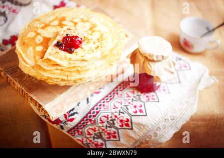 Homemade hot pancakes with jam. Rustic style, crepes closeup. Stock Photo