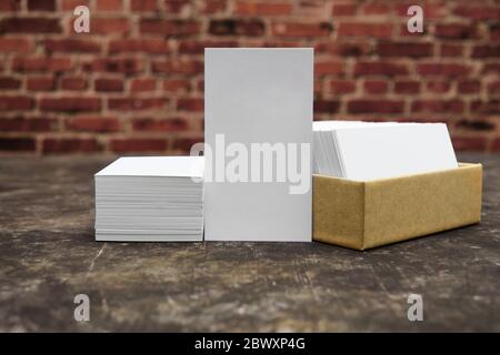 Business card mockup. Company identity presentation and corporate branding concept. Grunge style, red masonry background, selective focus. Stock Photo
