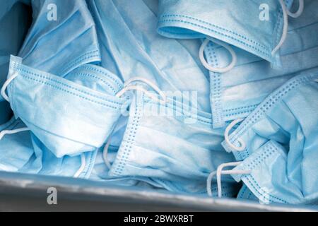 Medical protective mask in the trash. A medical mask is thrown out on ...