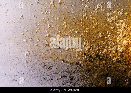Colorful mixed explosion of three ingredients: activated carbon, coconut and turmeric on grey background Stock Photo