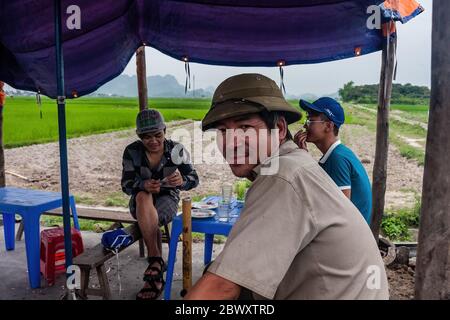 Vietnamese workers sitting in the shelter Stock Photo