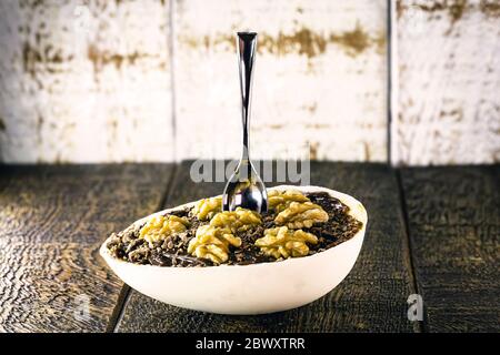 gourmet chocolate dessert with nuts on wooden background. Easter egg from brazil, easter 2020. Stock Photo