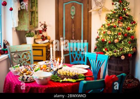 New Year or Christmas interior and festive table with a food. Stock Photo