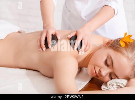 Beauty spa treatment and relax concept. Masseur makes procedures for girl Stock Photo