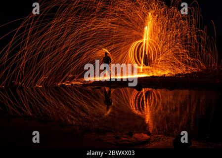 Long exposure and steel wool in the rockery on the beach of Balikliova Stock Photo