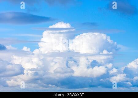 Powerful cumulus clouds in unstable stratification of the troposphere, weather with short-term rains and thunderstorms Stock Photo