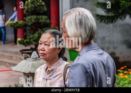 A senior Vietnamese couple in the Temple of Literature, Hanoi Stock Photo