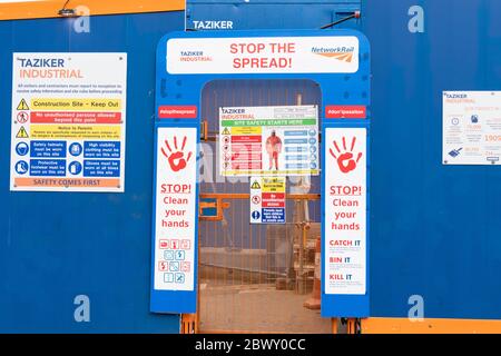 Coronavirus warning signs at entrance to construction site during the Clyde rail bridge renovation work by Taziker Industrial, Glasgow, Scotland, UK Stock Photo