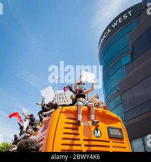 Protesters on top of a bus at a Black Lives Matter protest over the killing of George Floyd: Fairfax District, Los Angeles, CA, USA, May 30, 2020 Stock Photo