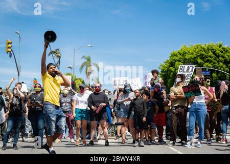 Activist with bullhorn at Black Lives Matter protest over the killing of George Floyd: Fairfax District, Los Angeles, CA, USA - May 30, 2020 Stock Photo