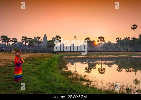 Cambodian child at sunrise at Angor Wat, Siem Reap, Cambodia. Stock Photo