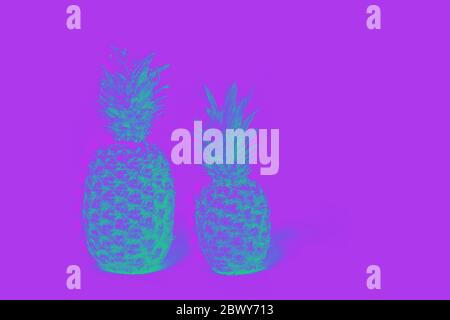 Two pineapples isolated on a lilas background. glitch effect Stock Photo