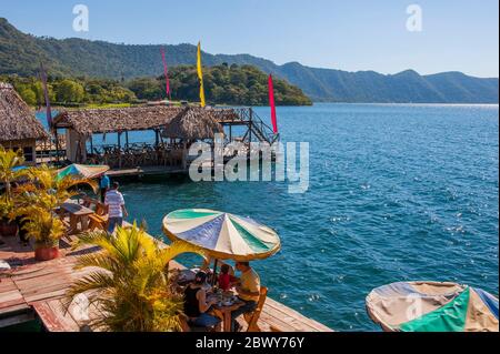 A restaurant on the shore of Lake Coatepeque in the Caldera De Coatepeque, a volcanic caldera in El Salvador in Central America. Stock Photo