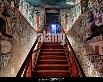 Lower East and West walls show almost mirror images of the black jackal Anubis reclining on a shrine on either side of the Inner Ramp and Staircase Stock Photo