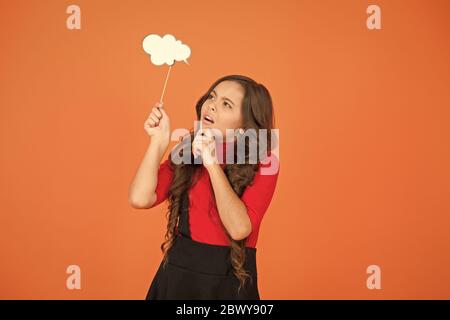 Remembering. Childhood memories. Speech bubble. Girl hold empty speech bubble copy space. Text bubble concept. Communication thinking and making decision. Read her thoughts. Kid show sign bubble. Stock Photo