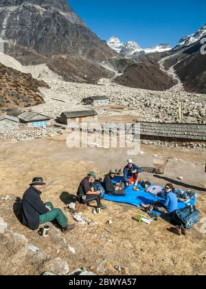 Nepal. Trek to Mera Peak. A group of European trekkers relaxing at the tiny Yak herders settlement of Tagnag Stock Photo