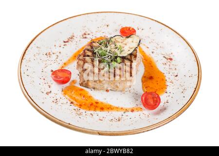 Pork steak served on a plate with sauce and microgreens. Stock Photo