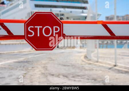 Stop sign in barrier. Closed border. Travel restrictions. Stock Photo