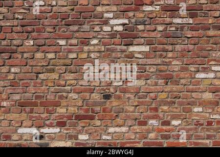 Real vintage Bumpy, rough and old brick texture with imperfect, dilapidate, impair, corroded and defective English brick bond pattern. Stock Photo