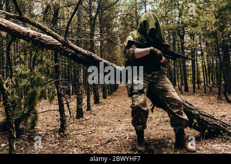 A Camouflaged Sniper Sitting In The Woods Aiming Through His Scope Stock  Photo, Picture and Royalty Free Image. Image 42659284.