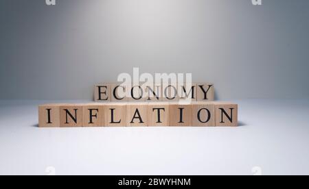 Inflation word written on wood cube with gray background. Stock Photo