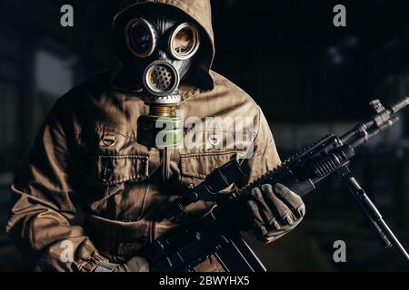 Photo of a stalker man in soviet gas mask and skull face closeup view ...