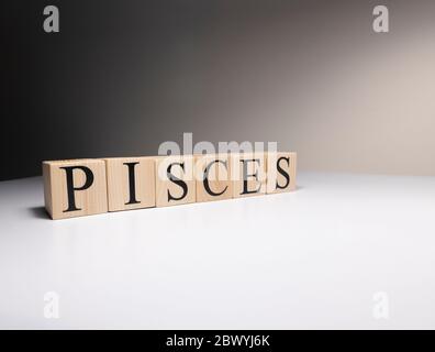 Pisces word on wooden cubes on white background. Stock Photo