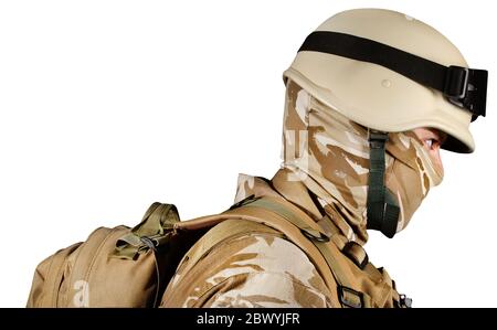 Isolated photo of a desert soldier in uniform with helmet and backback, profile view. Stock Photo