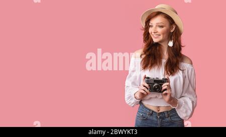 Cheerful Female Photographer Holding Photo Camera, Panorama, Studio Shot Stock Photo