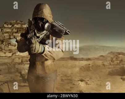 Photo of a desert post-apocalyptic soldier in tactical jacket, gas mask, gloves, rifle and armor standing aiming on evening wasteland background front Stock Photo