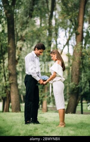 Couple Getting Married Standing Holding Hands During Ceremony In Forest Stock Photo