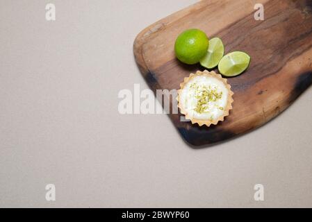 Top view of delicious lemon tart. Food concept Homemade organic Lemon, lime tarts or mini pie on a wooden board. Copy space. Selective focus. Stock Photo