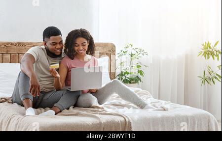 Young african couple happy to make purchases online Stock Photo