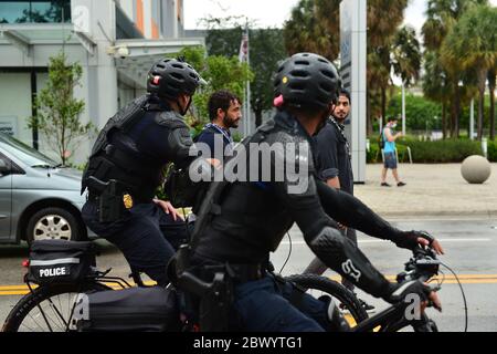 MIAMI, FL - June 02: Police officer are seen following the protestors as they holding signs and marching as they shut down traffic against police brutality and the recent death of George Floyd in front of the State Attorney for Miami-Dade County in Florida office Katherine Fernandez Rundle, Wynwood District and Overtown Historic District on June 02, 2020 in Miami, Florida. Protests continue to be held in all 50 States and cities throughout the country over the death of George Floyd, who was killed while in police custody in Minneapolis on May 25th. Credit: MPI10/MediaPunch Stock Photo