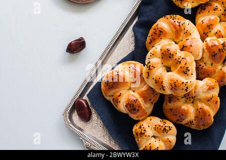 Homemade turkish bagel pogaca with nigella seeds. Freshly backed swirl buns. Stock Photo