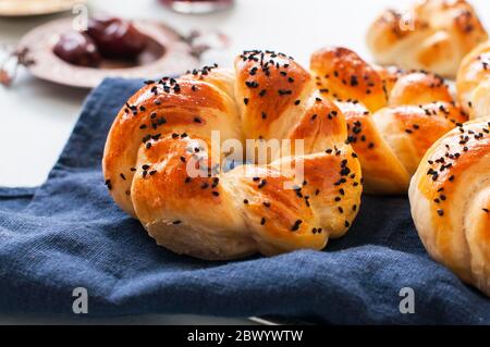 Homemade turkish bagel pogaca with nigella seeds. Freshly backed swirl buns. Stock Photo