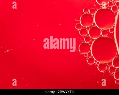 Bright scarlet red textured design of oil on water bubble abstract background Stock Photo