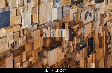 Background texture of wooden bars of different sizes, colors and textures lined up in the form of a wall. Stock Photo
