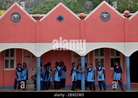 Female students are waiting for a daily briefing session after classes, to review the whole activities of the day and to arrange extracurricular activities, at Sujata Academy complex, a free school and dormitory for rural children in Dungeshwari, Bihar, India. Stock Photo