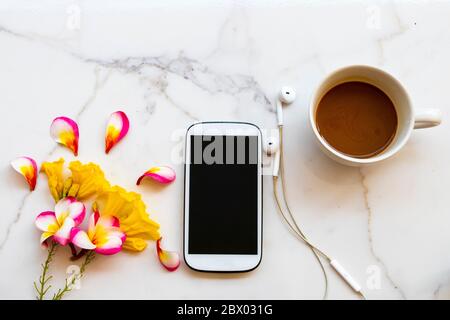 mobile phone ,earphone and yellow flowers frangipani arrangement flat