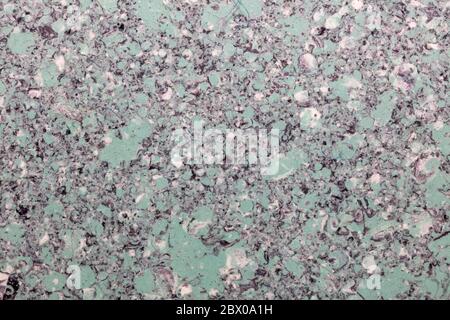 Grainy light green plastic surface. Top view. Close-up shot. Abstract idea. Stock Photo